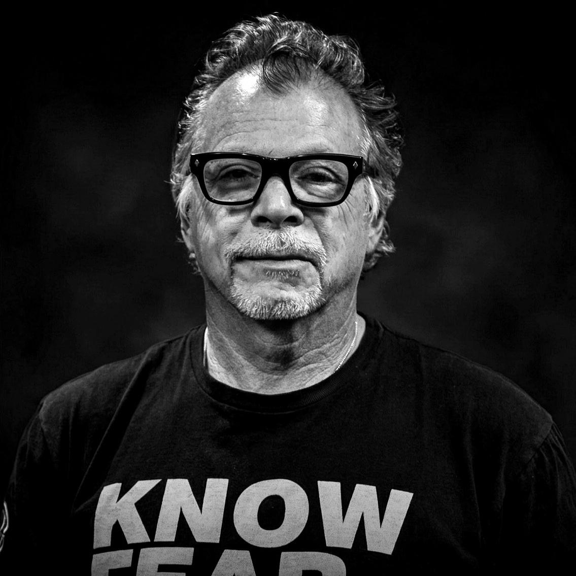 Black and white portrait of Tony Blauer wearing a KNOW FEAR shirt